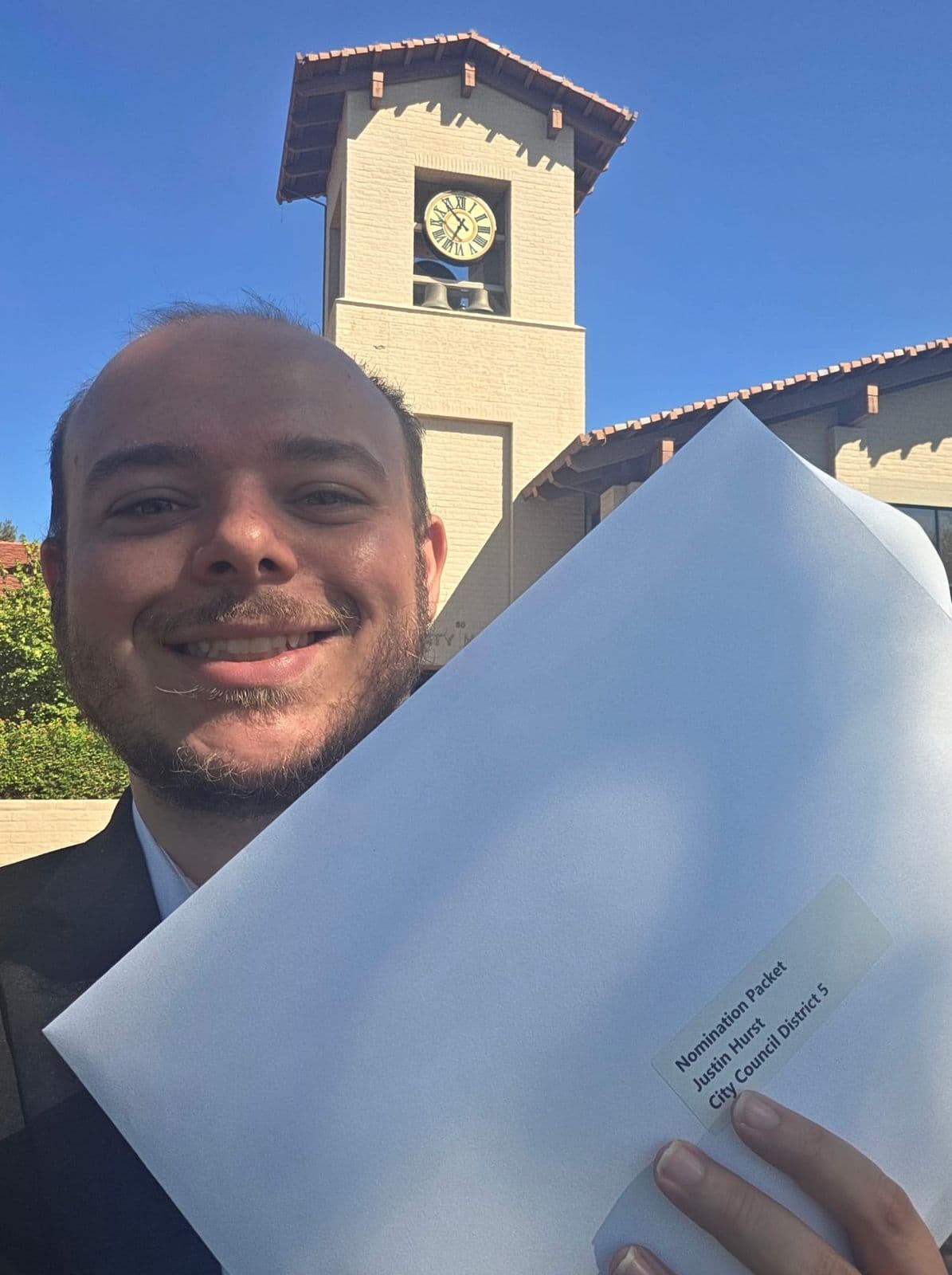 Justin holding his City Council District 5 nomination packet outside Folsom City Hall
